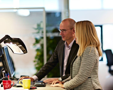 Photo of two people working